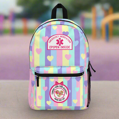 Backpack with colorful striped pattern and emergency medical labels on a white background