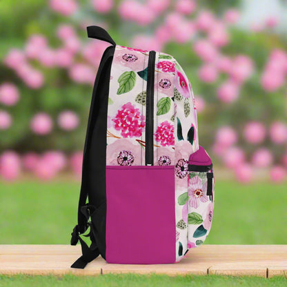 Floral-patterned backpack with a pink accent on a white background