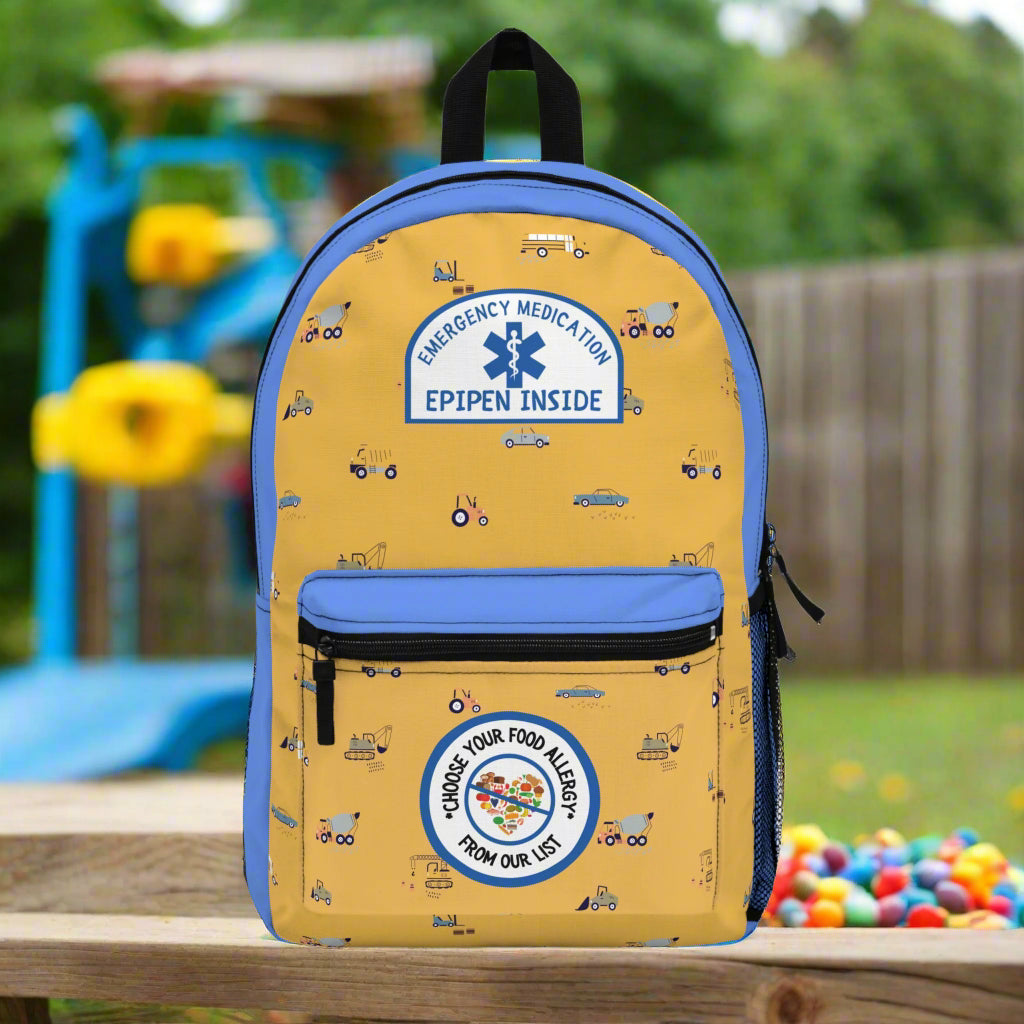 Yellow backpack with blue accents and medical-themed designs on a white background