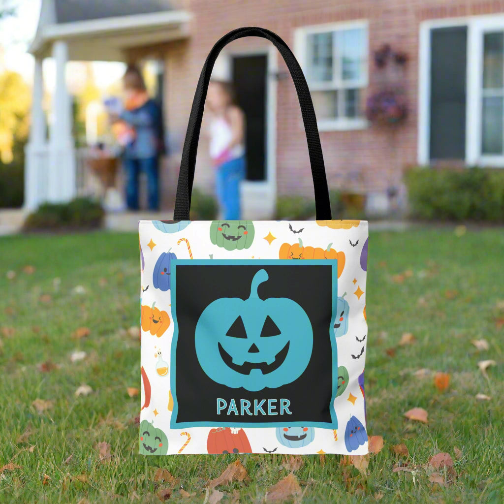 Halloween-themed tote bag with a pumpkin design and text, on a blurred background.