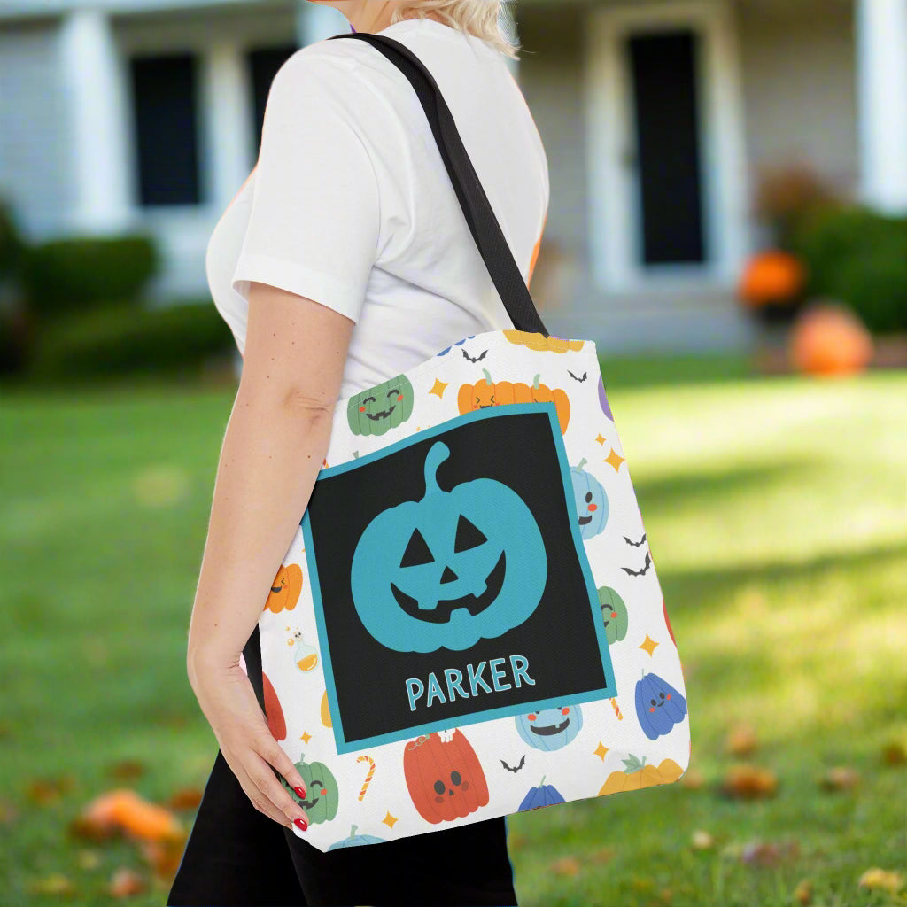Person holding a Halloween-themed bag with colorful designs.