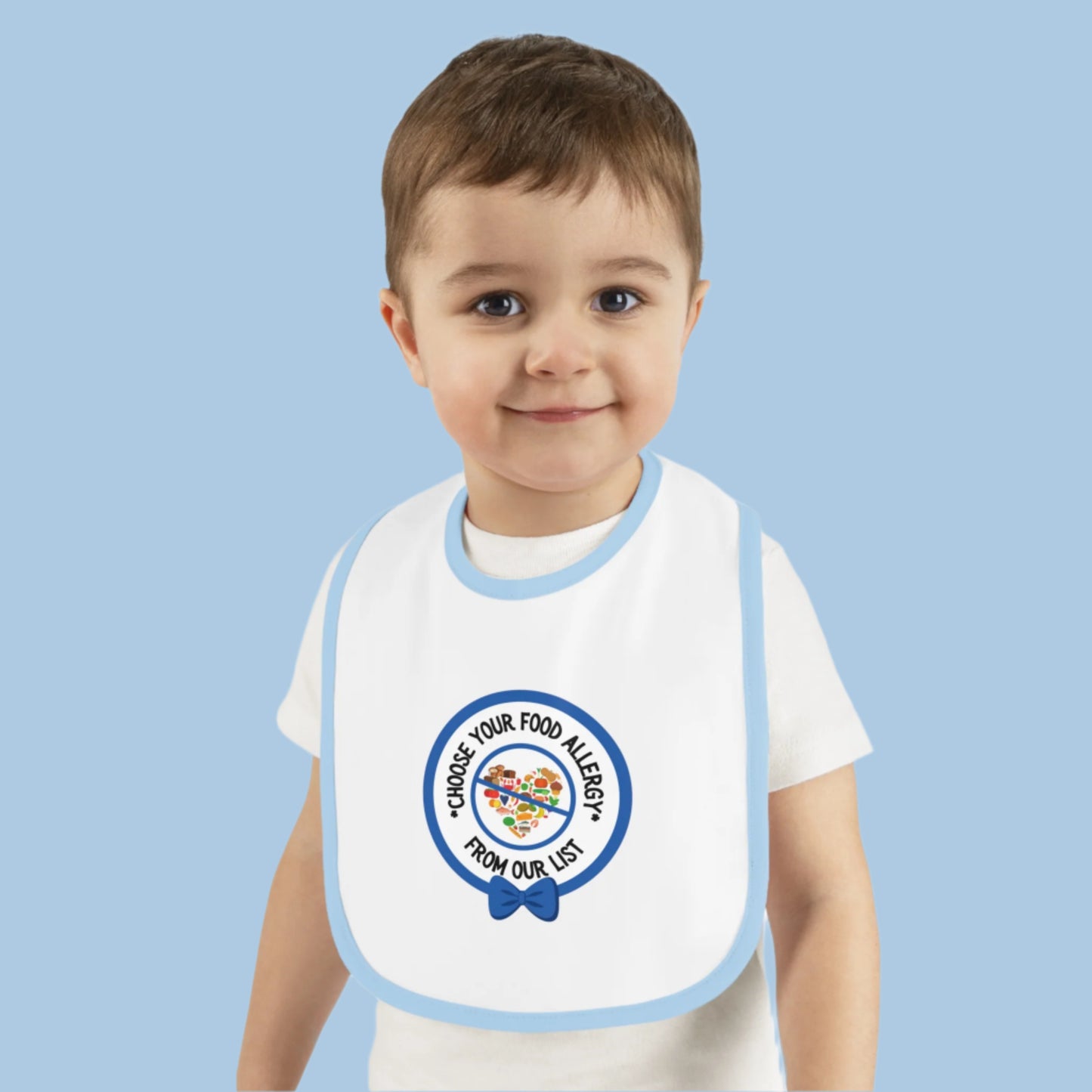 Baby wearing a personalized blue food allergy bib designed for mealtime allergy awareness and safety