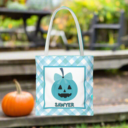 Halloween-themed teal and white tote bag with a pumpkin design and text.